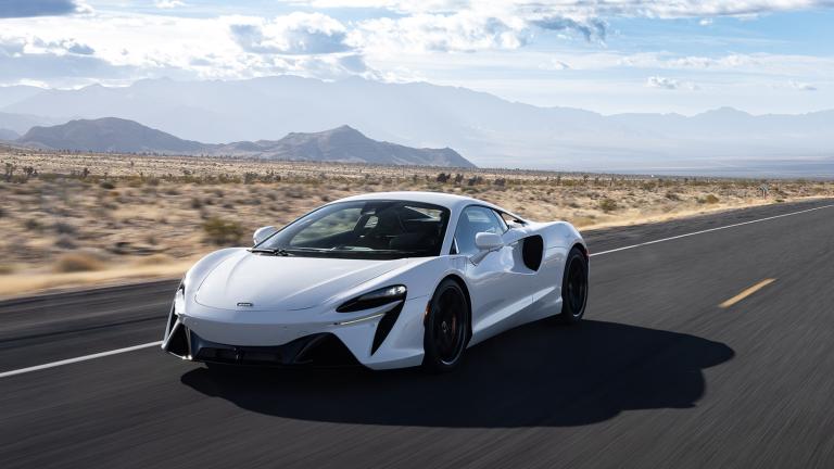 2023 McLaren Artura in white front left driver side driving in the desert